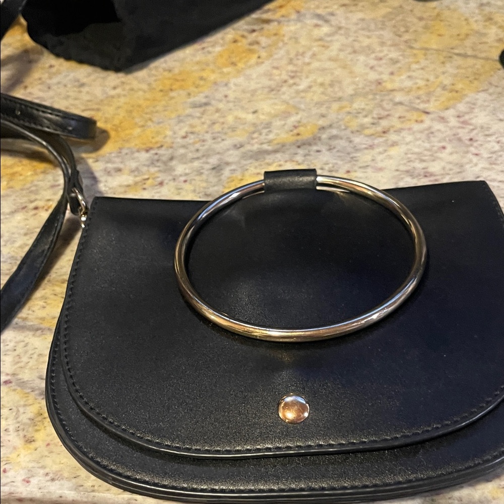 Chic Black Handbag with Gold Ring Accent
